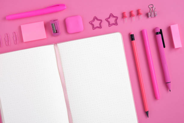 istock Empty notebook page for your text with pink stationery on magenta background. 1659224552