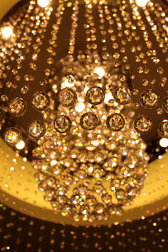 Close up of cut glass lit chandelier.