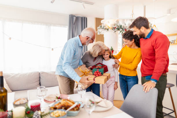 istock Family exchanging Christmas presents at home 1659281201