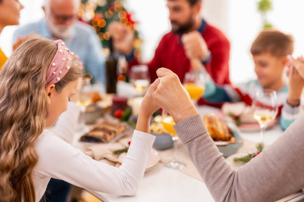 istock Family praying while having Christmas dinner at home 1659284276
