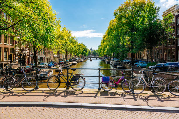 istock Canal in Amsterdam with Bicycles, Boats, and Trees. 1659285381