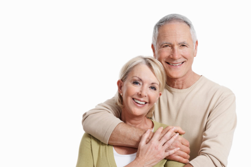 Portrait of cute senior couple smiling together over white background