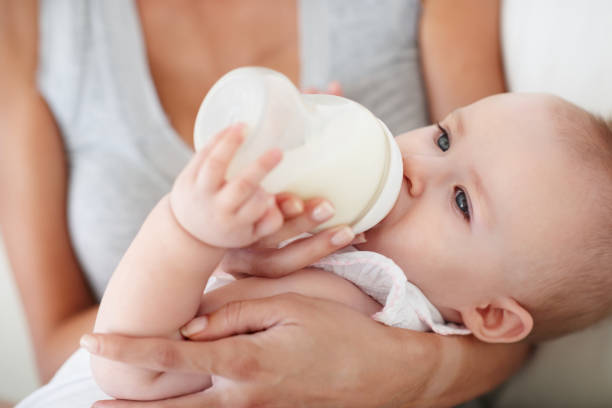 Baby girl drinking milk from bottle