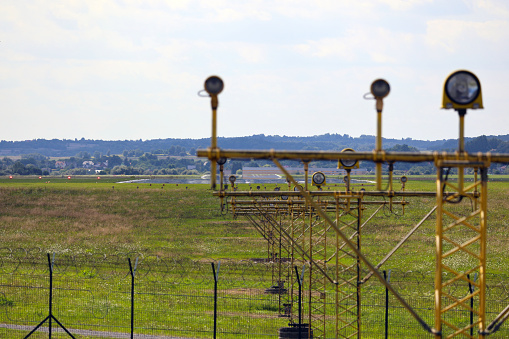 Signal poles in front of the runway, on the landing path. View of the runway. PAPI signaling lighting