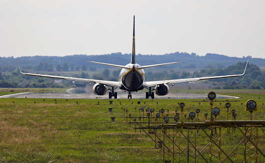 Airplane taxiing to the runway. In the foreground, PAPI signal lighting