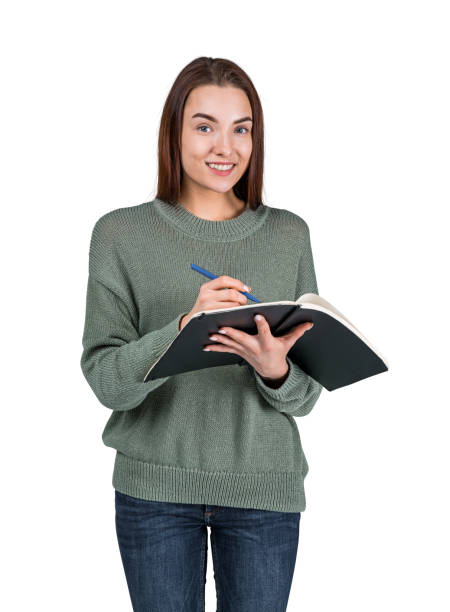 istock Young woman taking notes and smiling, isolated over white background 1659296858