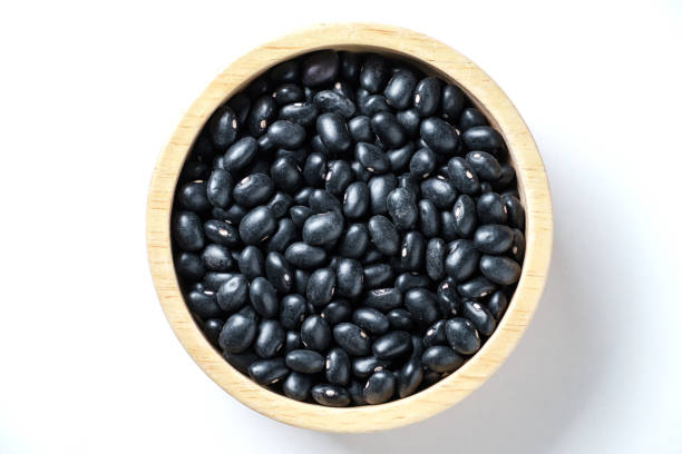 istock Black lentil In a wooden cup. 1659298021
