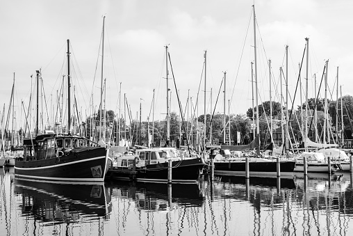 Sailing yachts and fishing boats moored in marina.Netherlands.BW