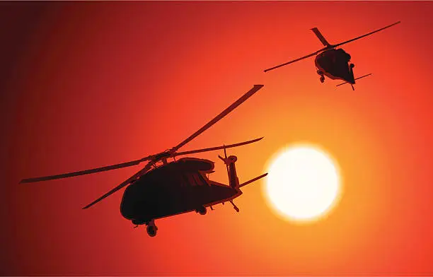 Vector illustration of UH-60 Blackhawk transport helicopters passing by as the sun sets