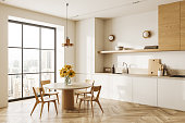 White kitchen corner with cabinets and table