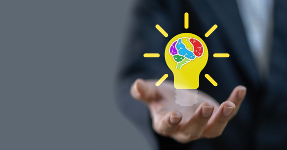 Businessman holding light bulb, colorful human brain smart thinking brainstorming creative idea,creative intelligence mind,education knowledge study and learn,science and innovation