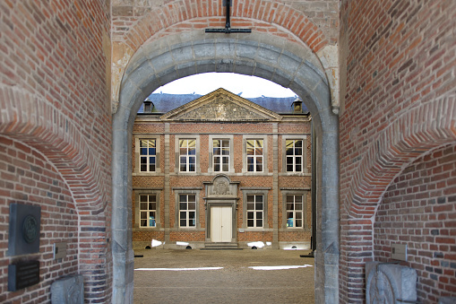 Beautiful  16th century Alden Biesen castle inner courtyard seen through a porch in Limburg, Belgium.