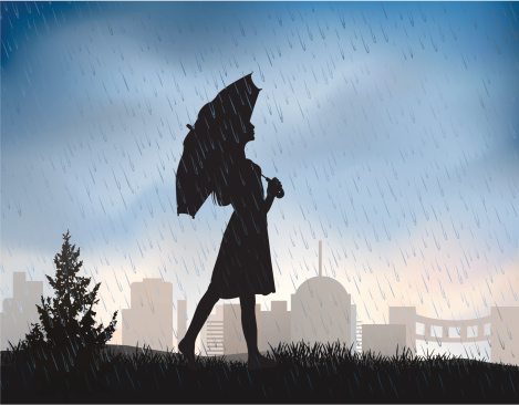 A silhouette of a girl who walks barefoot in the rain.