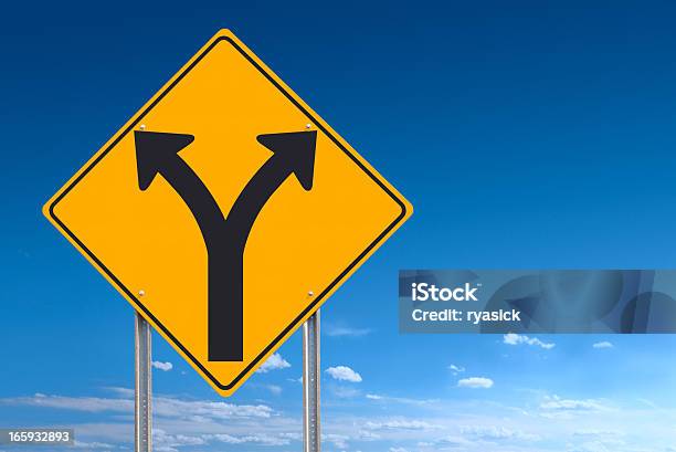 Choice Or Division Ahead Road Sign Post On Blue Sky Stock Photo - Download Image Now