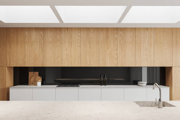 istock Stylish kitchen interior with bar countertop and wooden cabinet with kitchenware 1659332025