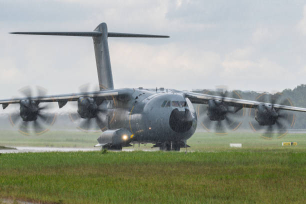 istock Military Cargo aircraft taxiing under rain 1659332577