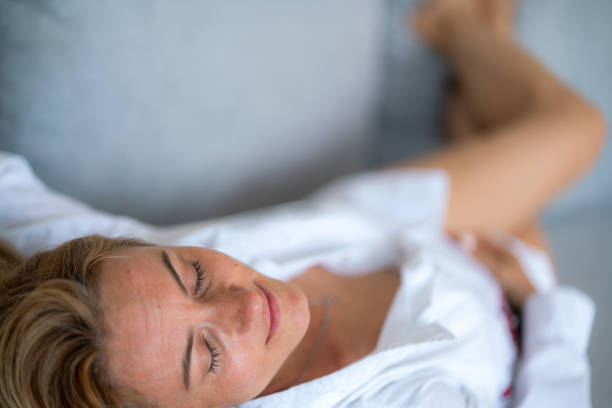 istock Happy woman lying on the sofa whit her eyes closed 1659346498
