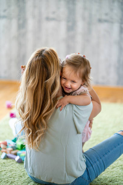 istock Mother and daughter embracing at home 1659349875