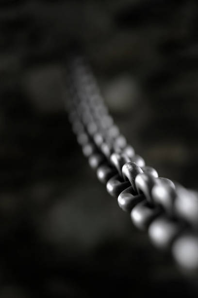 istock Heavy Steel or Iron Chain Fastened Into Rock Wall 1659386268