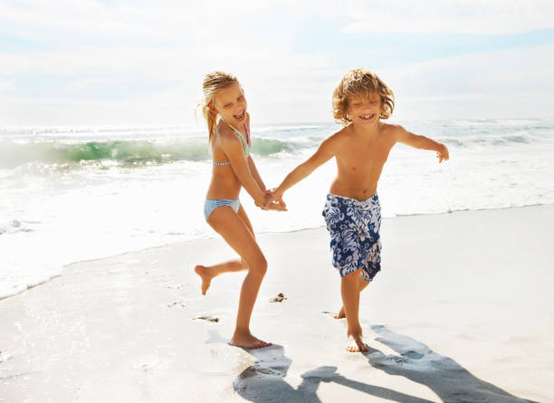 istock Kids enjoying summer vacation at the beach 165940800