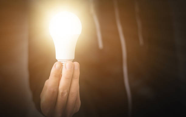 istock hand holding light bulb. idea concept with innovation and inspiration. 1659408989