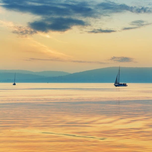 sailboats on the lake at sunset. Location: Lake Balaton, Hungary
