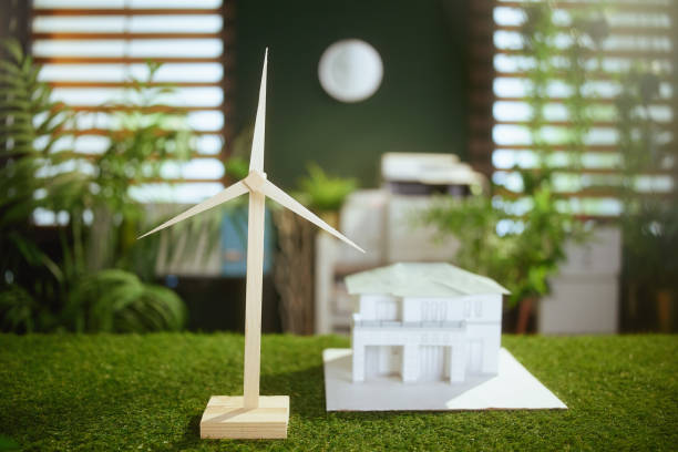 istock grass desk in modern green office with paper house and windmill 1659414948