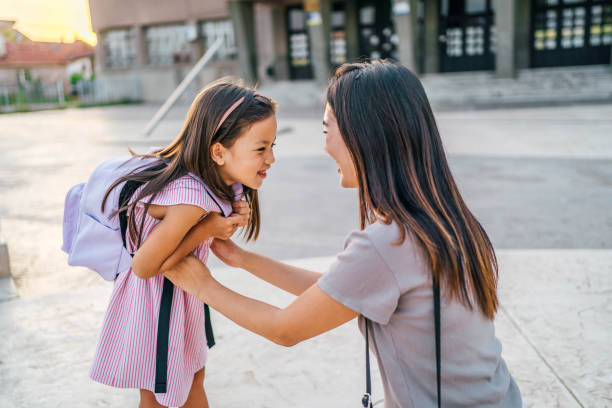 istock Mother sending her daughter to school 1659419904