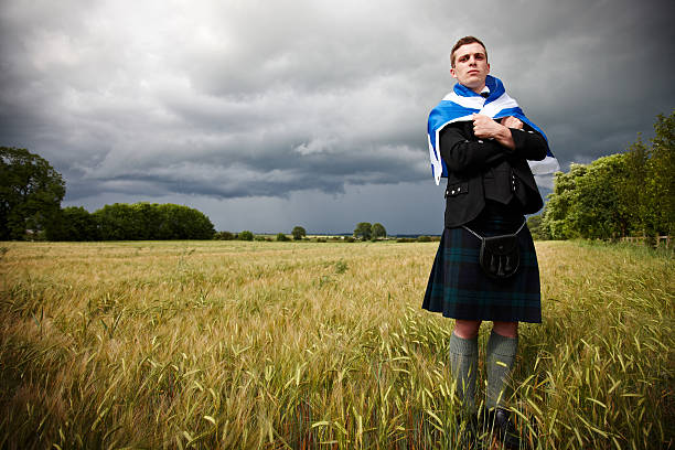 istock Proud scotsman in cornfield with kilt and saltire 165942936