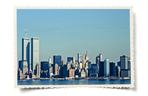 Retro-styled colour photo (my own, taken February 1988) of Lower Manhattan skyline, including the Twin Towers, layered on a serrated photo border with added vintage effects. Isolated on white with a soft shadow. Clipping path provided for the serrated edge outline. Photo scanned from 35 mm slide film (Kodachrome 64).
