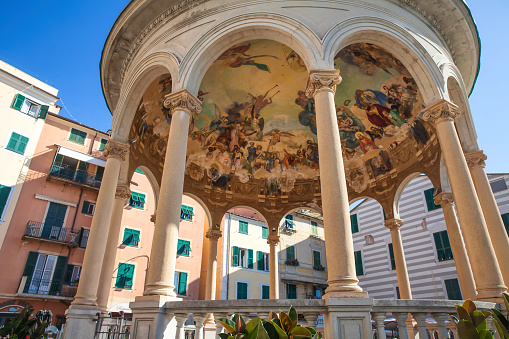 Hotel du Lac in Menaggio, Italy, with a car parked in front and people walking on the sidewalk