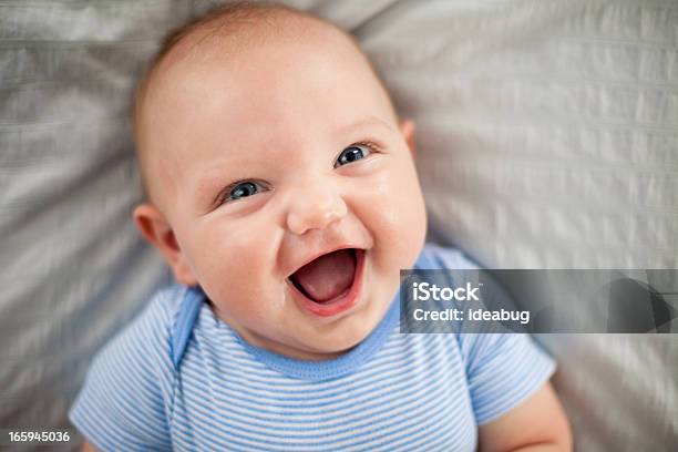 Happy Laughing Baby Boy Lying On Textured Fabric Stock Photo - Download Image Now - Baby - Human Age, Smiling, Laughing