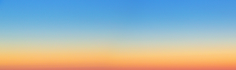 Natural panoramic background. The sky before sunrise. The firmament after sunset. Colored smooth transitions from blue to orange.