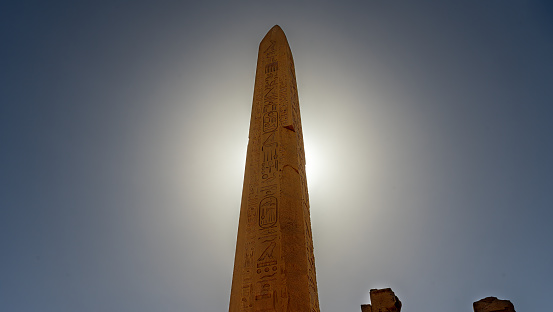 Obelisk of Thutmose I with the sun directly behind it