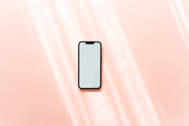 istock White blank path screen mobile phone with mockup on neutral pink background with shadows. 1659486629
