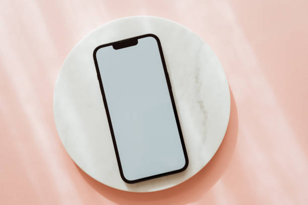 istock White blank path screen mobile phone with mockup copy space on white marble podium on pink background with shadows 1659486965