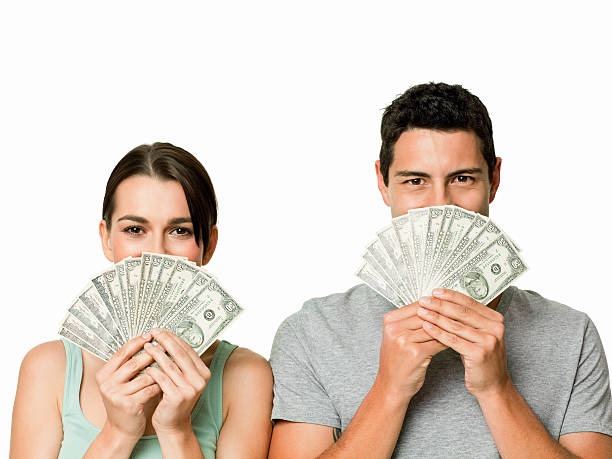 istock Young Couple Holding Up Money - Isolated 165949258