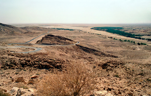 view of the rocks and the oasis ofJnane Dhaoui in the distance