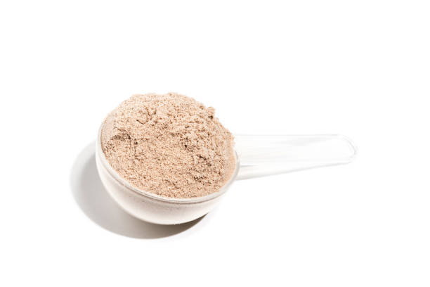 istock Chocolate protein powder in measuring spoon isolated on white background 1659494772