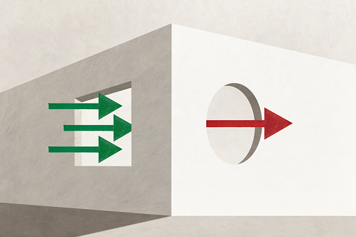 Green arrows flow in and a red  arrow flows out of large windows in a concrete structure that illustrates the concept of positive cash flow.