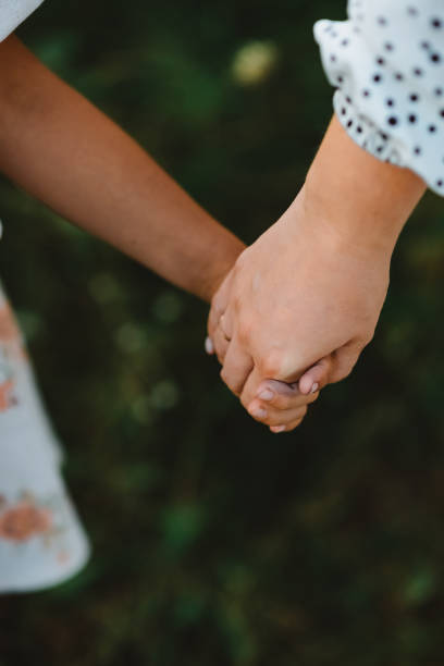 istock A mother holds her child's hand 1659502449