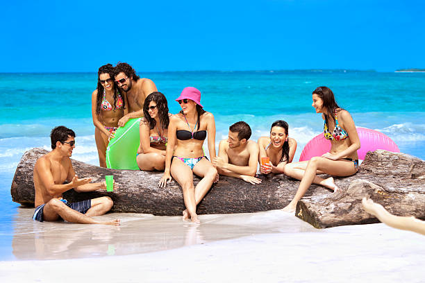 istock Happy friends talking on a tropical turquoise beach 165951328