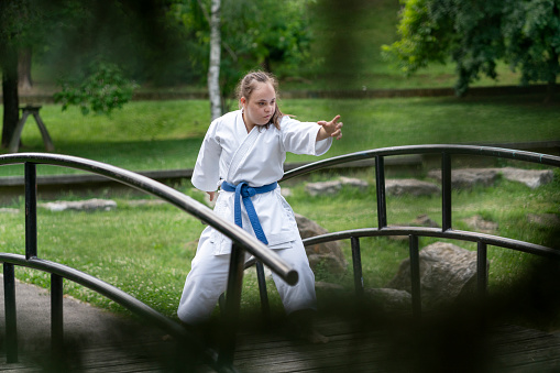 Young woman with Down syndrome practices karate