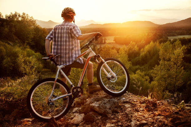 istock Mountain biker resting before downhill and looking in sunset 1659526831