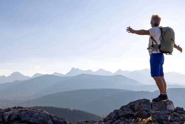 istock Mature male hiker arrives on mountain summit 1659546227