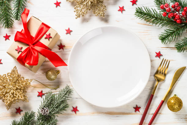 istock Christmas table setting with holiday decorations and preset box at white wooden table. 1659549428