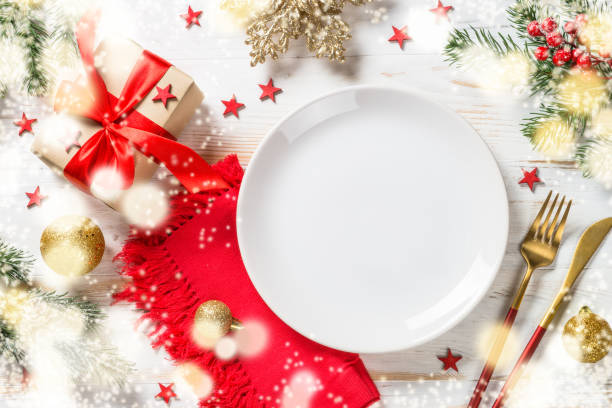 istock Christmas table setting with holiday decorations and preset box at white wooden table. 1659550498