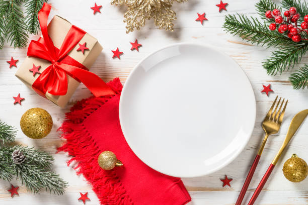 istock Christmas table setting with holiday decorations and preset box at white wooden table. 1659550501