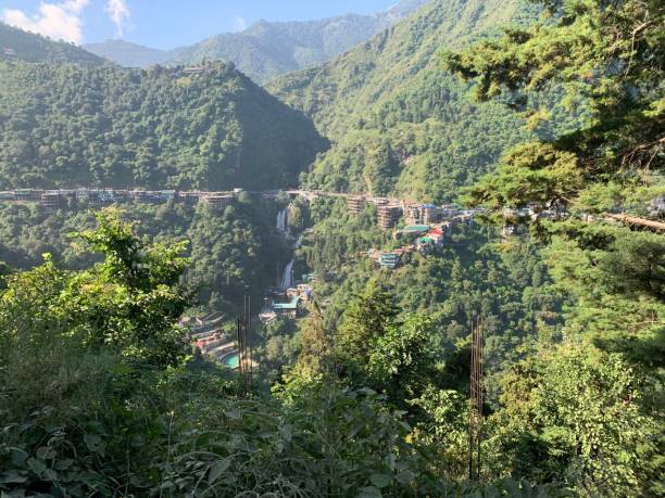 istock the valley is lined with mountains, a bridge and many small buildings 1659564870