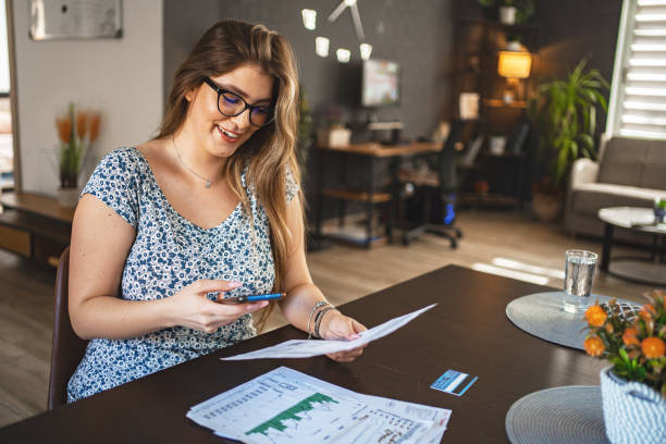 istock Young brunette woman paying financial bills with mobile phone and QR code scanner 1659575779